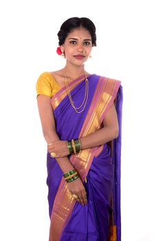 Beautiful Indian young girl posing in traditional Indian saree on white background.