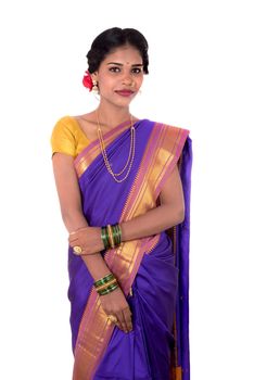 Beautiful Indian young girl posing in traditional Indian saree on white background.