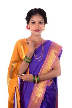 Beautiful Indian young girl posing in traditional Indian saree on white background.