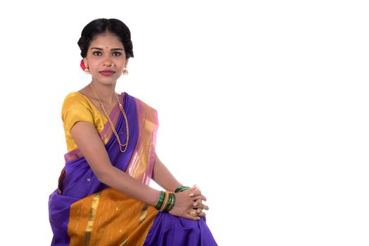 Beautiful Indian young girl posing in traditional Indian saree on white background.