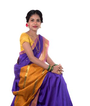 Beautiful Indian young girl posing in traditional Indian saree on white background.