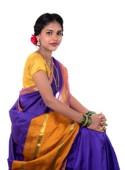 Beautiful Indian young girl posing in traditional Indian saree on white background.