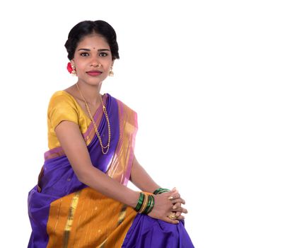 Beautiful Indian young girl posing in traditional Indian saree on white background.