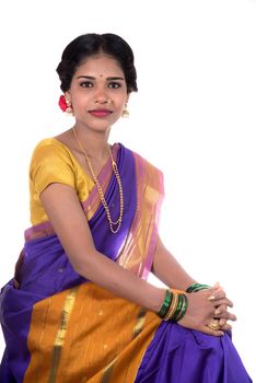 Beautiful Indian young girl posing in traditional Indian saree on white background.