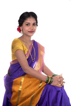 Beautiful Indian young girl posing in traditional Indian saree on white background.