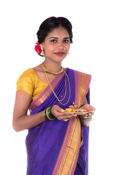 Indian woman performing worship, portrait of a beautiful young lady with pooja thali isolated on white background