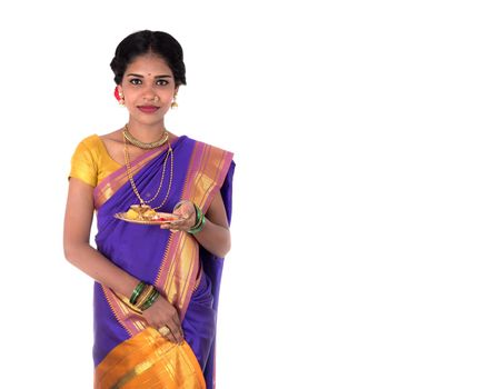 Indian woman performing worship, portrait of a beautiful young lady with pooja thali isolated on white background