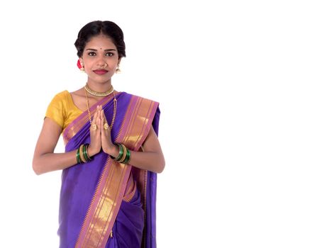 Young Indian girl in traditional clothing greeting namaste, Welcome, Indian girl in a tradition sari with welcome expression (inviting)