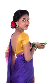 Portrait of a woman holding diya, Diwali or deepavali photo with female hands holding oil lamp during festival of light on white background