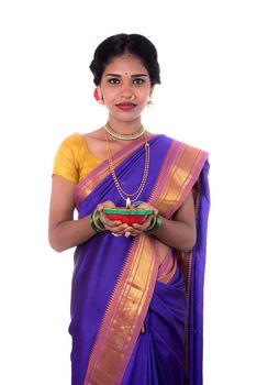 Portrait of a woman holding diya, Diwali or deepavali photo with female hands holding oil lamp during festival of light on white background