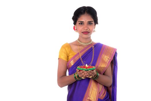 Portrait of a woman holding diya, Diwali or deepavali photo with female hands holding oil lamp during festival of light on white background