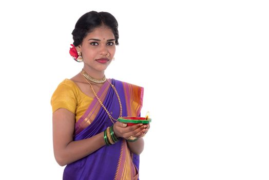 Portrait of a woman holding diya, Diwali or deepavali photo with female hands holding oil lamp during festival of light on white background