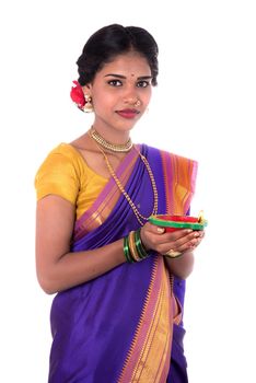 Portrait of a woman holding diya, Diwali or deepavali photo with female hands holding oil lamp during festival of light on white background