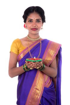 Portrait of a woman holding diya, Diwali or deepavali photo with female hands holding oil lamp during festival of light on white background