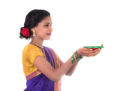 Portrait of a woman holding diya, Diwali or deepavali photo with female hands holding oil lamp during festival of light on white background