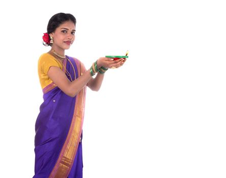 Portrait of a woman holding diya, Diwali or deepavali photo with female hands holding oil lamp during festival of light on white background