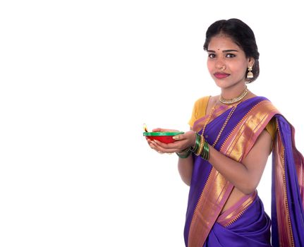 Portrait of a woman holding diya, Diwali or deepavali photo with female hands holding oil lamp during festival of light on white background