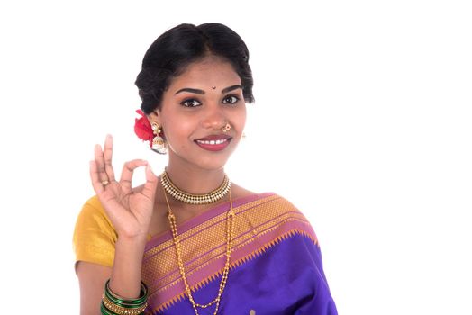 Beautiful Indian young girl posing in traditional Indian saree on white background.