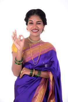 Beautiful Indian young girl posing in traditional Indian saree on white background.