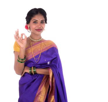 Beautiful Indian young girl posing in traditional Indian saree on white background.