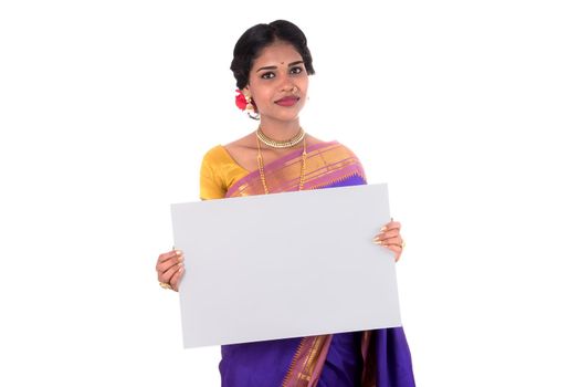 Traditional Girl holding and showing blank white sign board