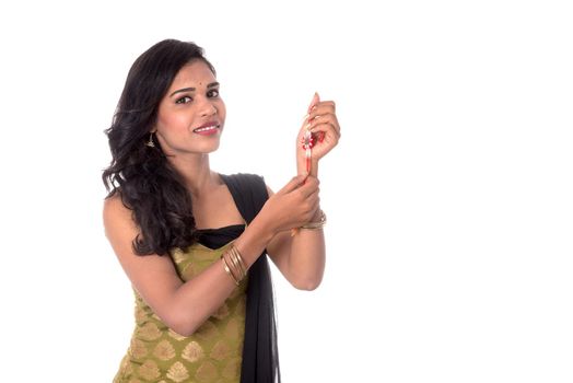 Beautiful Indian girl showing Rakhis on occasion of Raksha bandhan. Sister tie Rakhi as symbol of intense love for her brother.