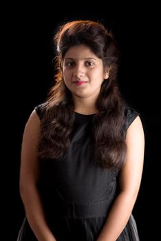 Portrait of beautiful young girl on black background