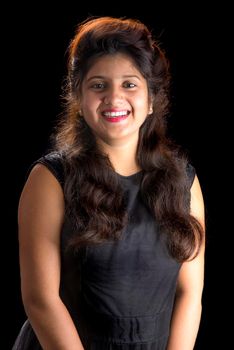 Portrait of beautiful young girl on black background