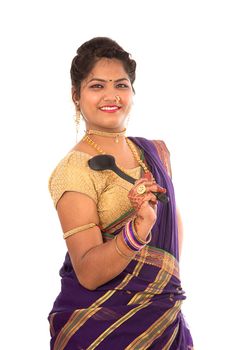 Young Traditional Indian Girl holding kitchen utensil on white background