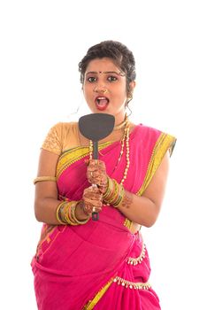 Young Traditional Indian Girl holding kitchen utensil on white background