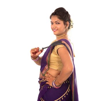 Young Traditional Indian Girl holding kitchen utensil on white background