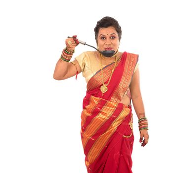 Young Traditional Indian Girl holding kitchen utensil on white background