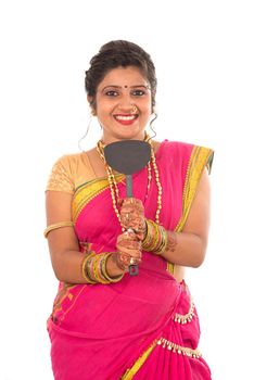 Young Traditional Indian Girl holding kitchen utensil on white background