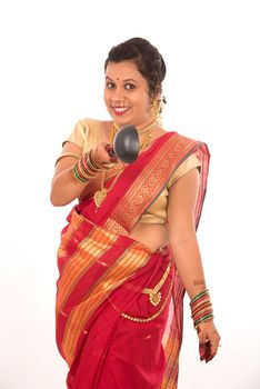 Young Traditional Indian Girl holding kitchen utensil on white background