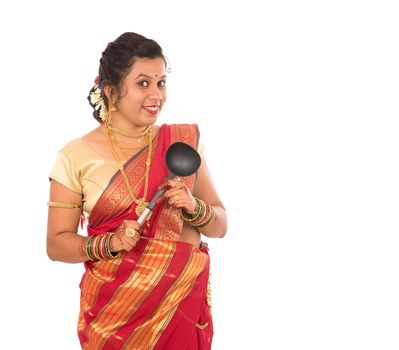 Young Traditional Indian Girl holding kitchen utensil on white background