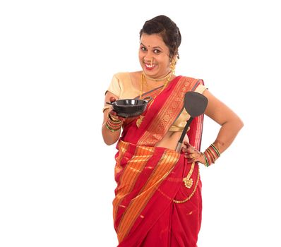 Young Traditional Indian Girl holding kitchen utensil on white background