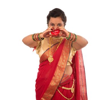 Traditional Beautiful Indian young girl in saree posing with Heart on white background