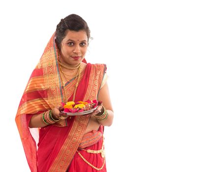 Portrait of a Indian Traditional Girl holding pooja thali with diya during festival of light on white background. Diwali or deepavali