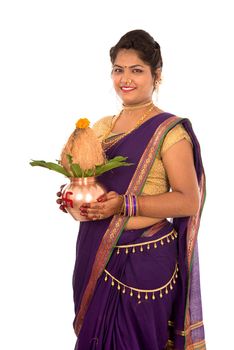 Indian Traditional Woman holding a traditional copper kalash, Indian Festival, copper kalash with coconut and mango leaf with floral decoration, essential in hindu puja.