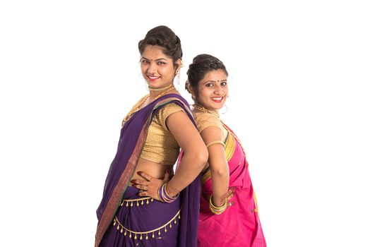 Traditional Beautiful Indian young girls in saree posing on white background