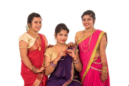 Traditional Beautiful Indian young girls in saree posing on white background