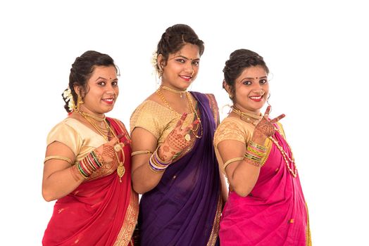 Traditional Beautiful Indian young girls in saree posing on white background