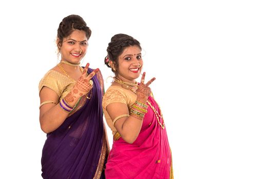 Traditional Beautiful Indian young girls in saree posing on white background