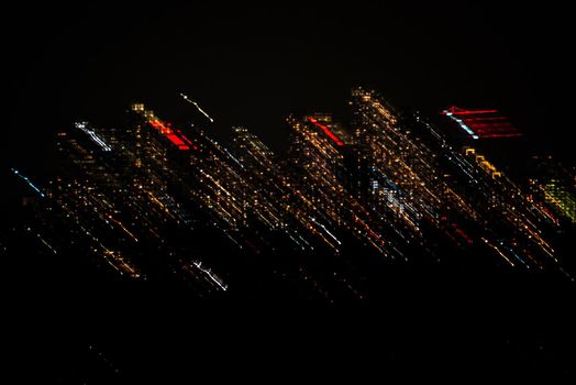 City lights thrown in a night. Abstract lights shift on black background.