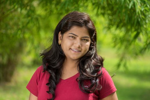 Portrait of beautiful Young girl outdoors in park.