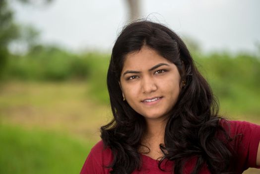 Portrait of beautiful Young girl outdoors in park.