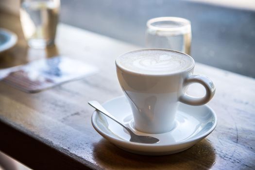 Cup of fresh brewed cappuccino in an Italian café