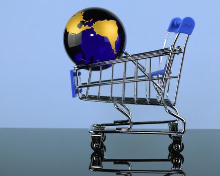 A shopping cart with the Earth inside for global shopping and marketing concepts.