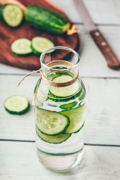 Infusion with sliced cucumber in glass bottle