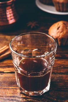 Turkish coffee with spices and oatmeal muffins on wooden surface